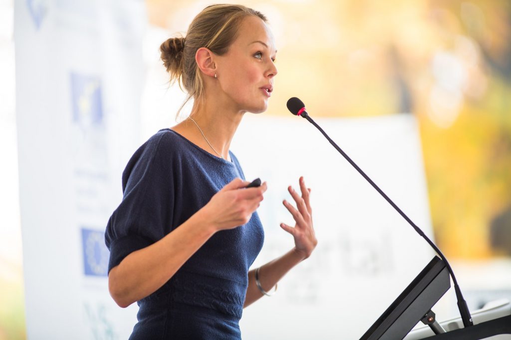 Pretty, young business woman giving a presentation Pretty, young business woman giving a presentation